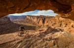 A mountain biker experiencing Moab's exhilarating mountaing biking trails near Lionsback Resort.