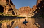 A person kayaking on the Colorado River, experiencing the beauty of Moab near Lionsback Resort.