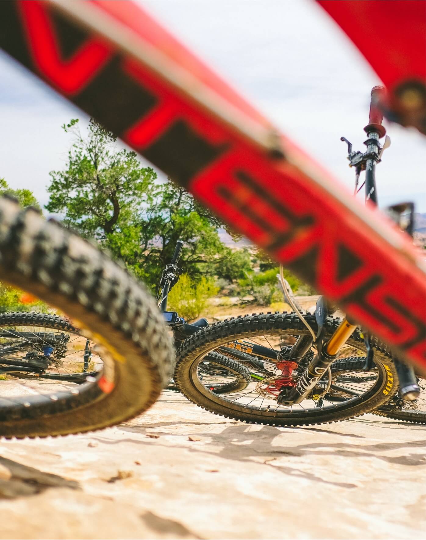 A closeup image of mountain bikes laying on the ground
