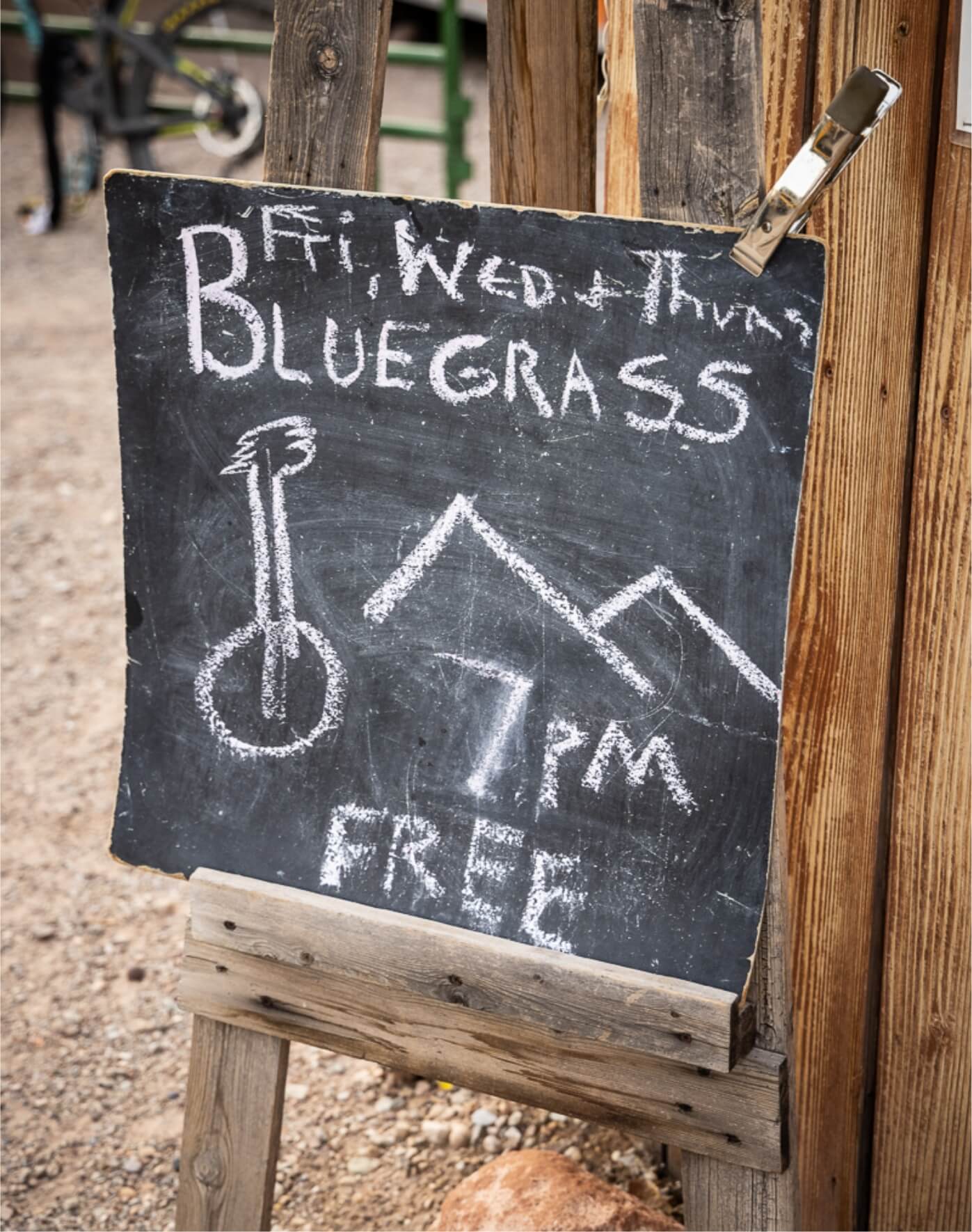 A chalkboard sign highlights free bluegrass concerts in Moab.