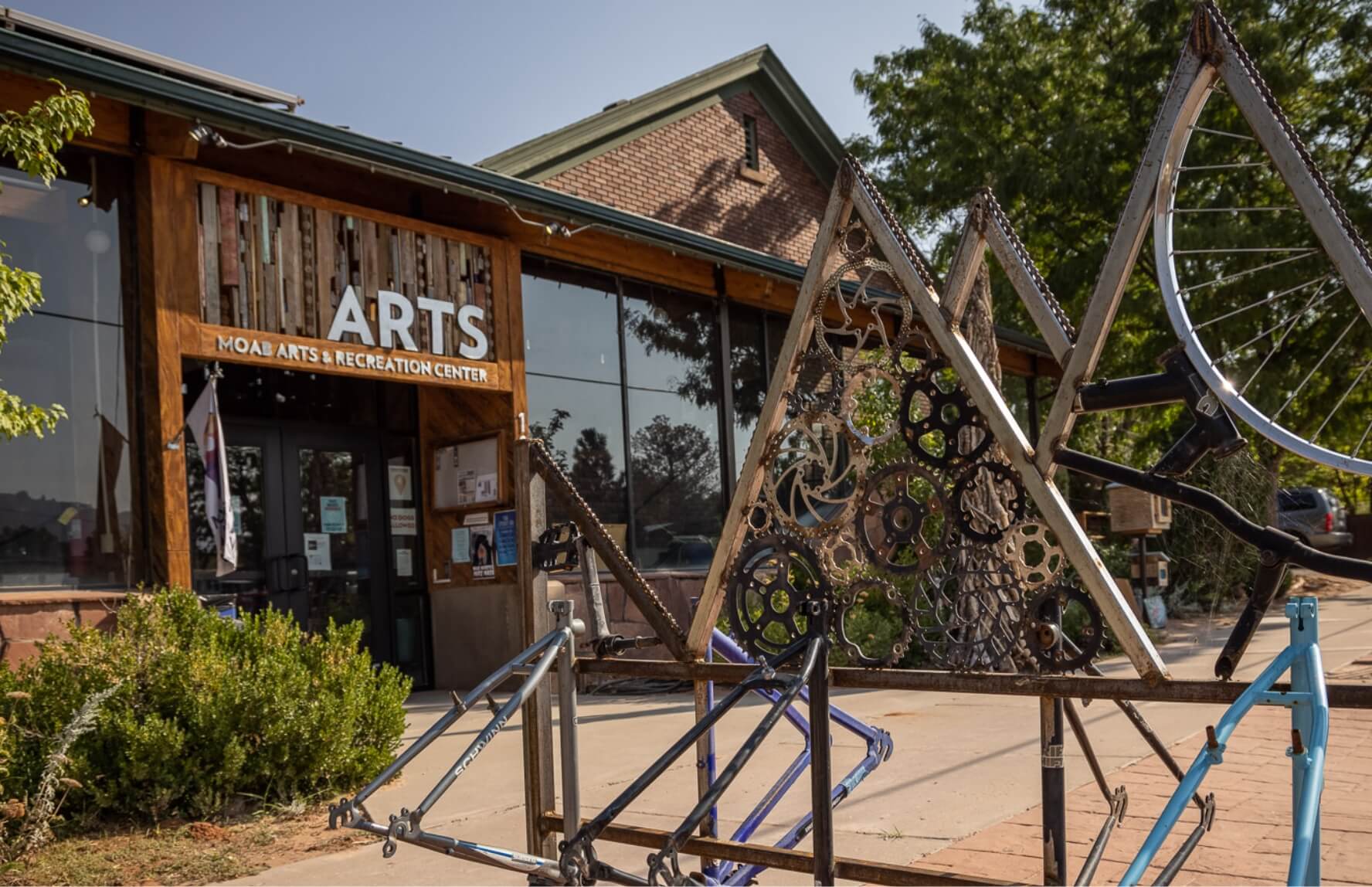 A bicycle rack made from bicycle parts in front of the Moab Arts & Recreation Center.