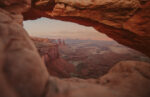 A view of the rocky desert of Moab through an arch rock.