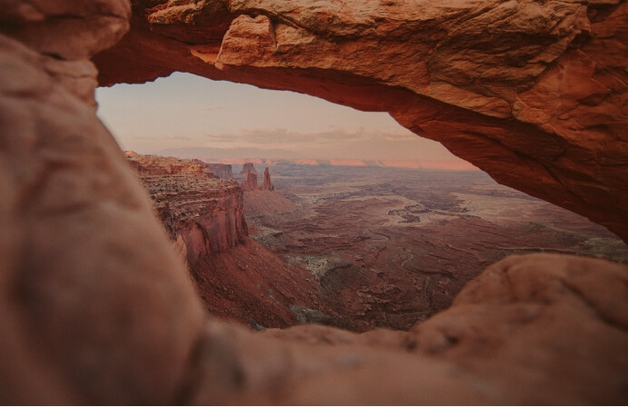 A view of the rocky desert of Moab through an arch rock.