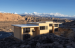 A Casita at Lionsback Resort in Moab with rocky desert and snow-capped mountains in the background.